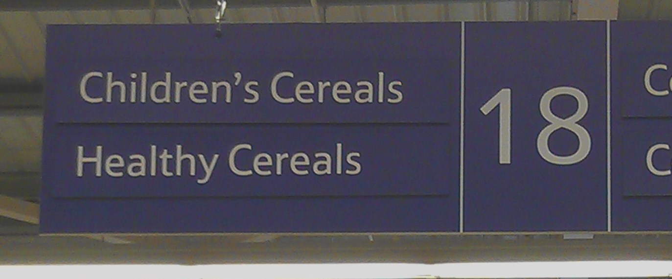 Supermarket aisle sign with "Healthy Cereals" and "Childrens Cereals"